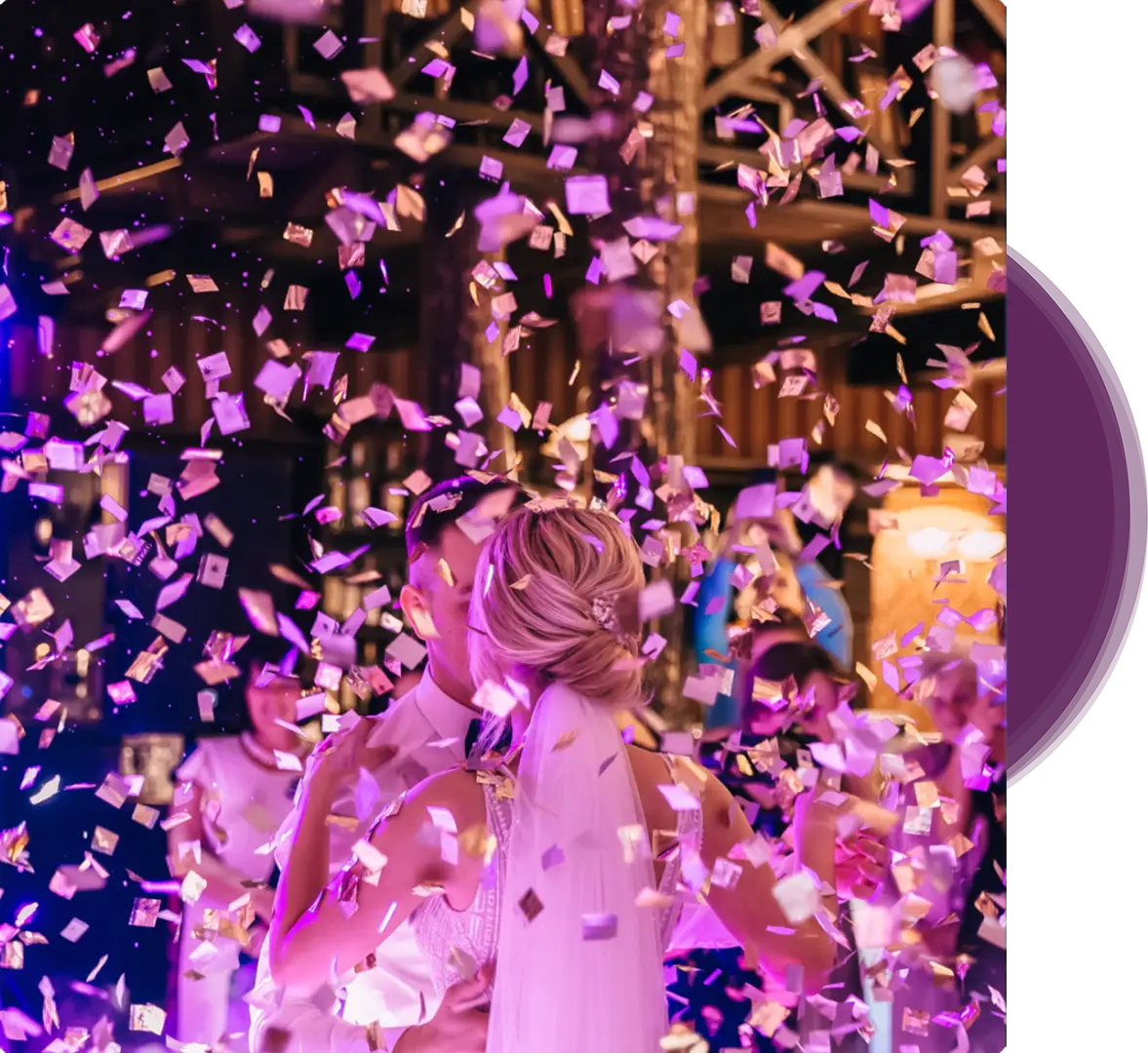 A woman standing in front of a crowd with purple confetti.