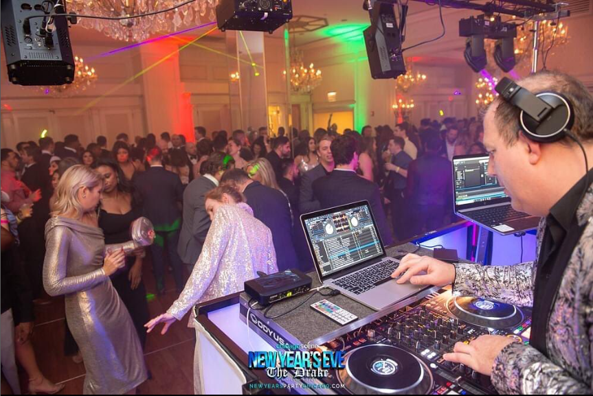 A dj is setting up his equipment for the party.