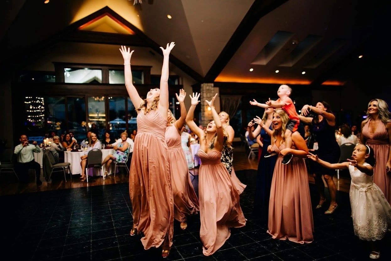 A group of people in dresses dancing on the dance floor.