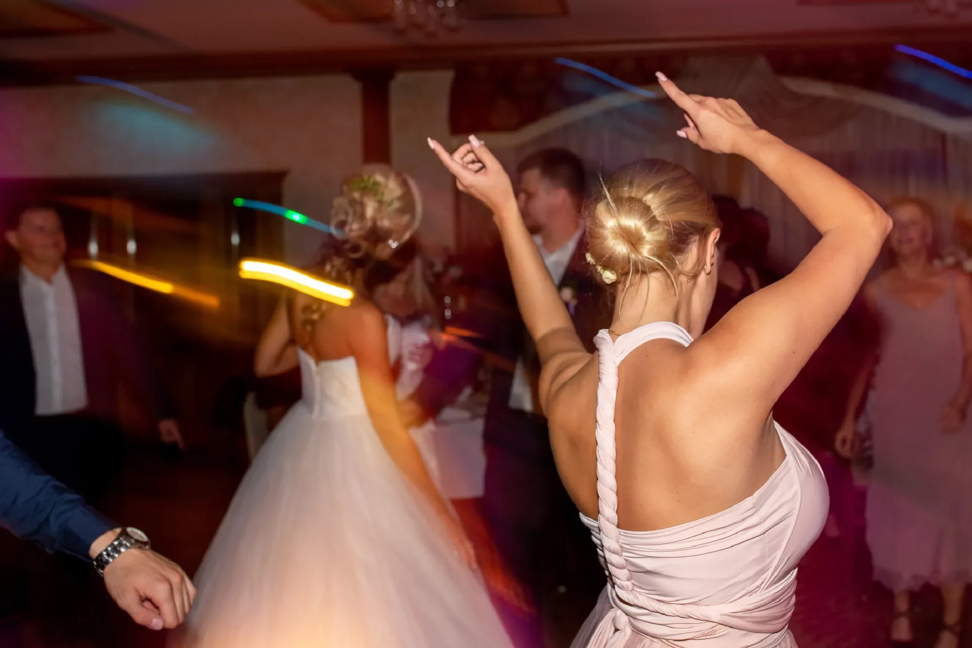 A group of people dancing in the middle of a room.