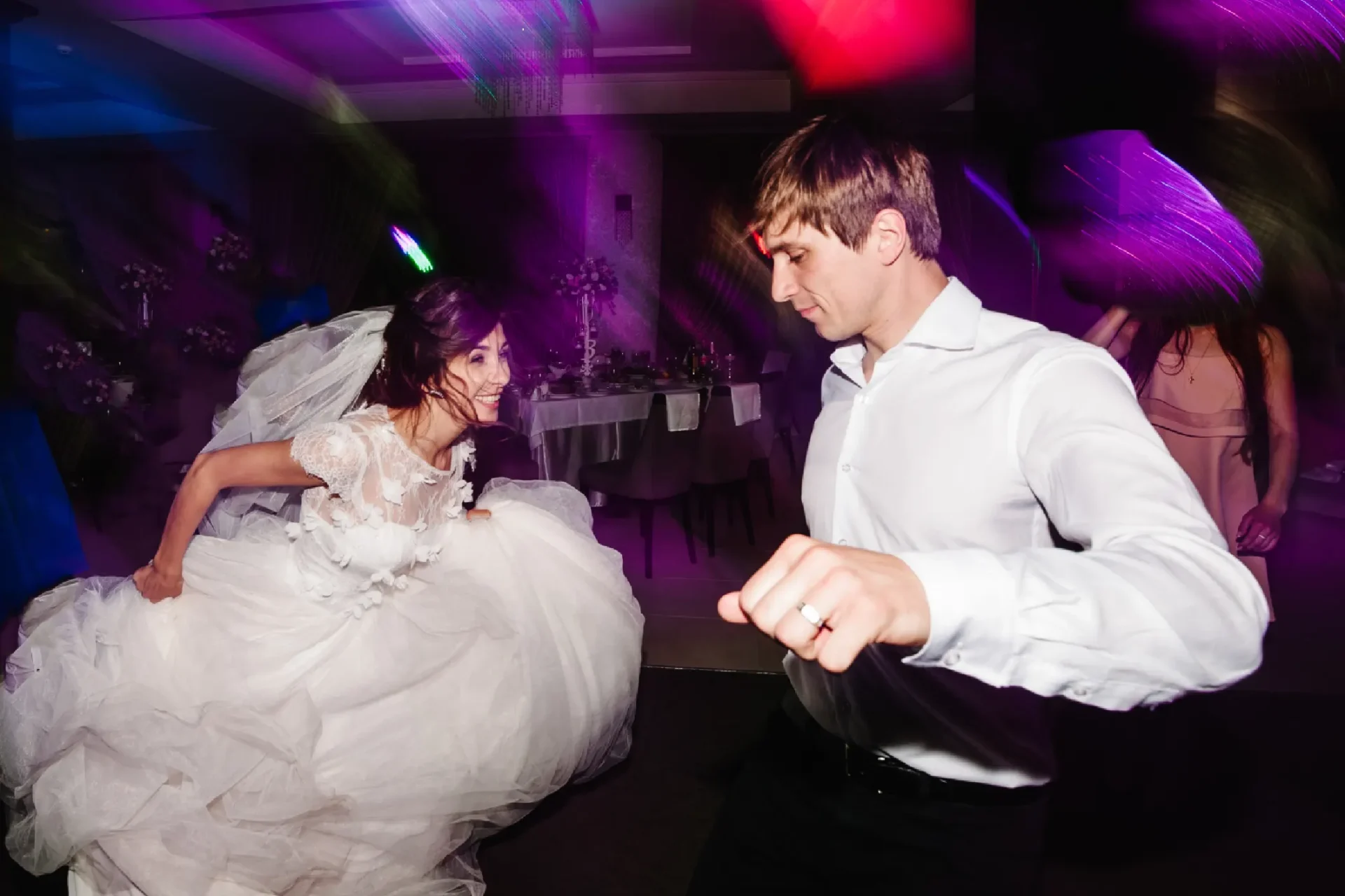 A man and woman dancing in the middle of a room.