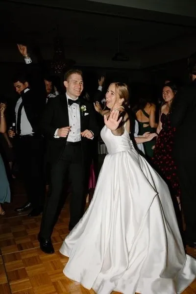 A man and woman dancing in front of other people.