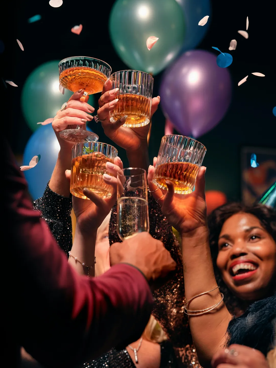 A group of people holding up glasses with beer.